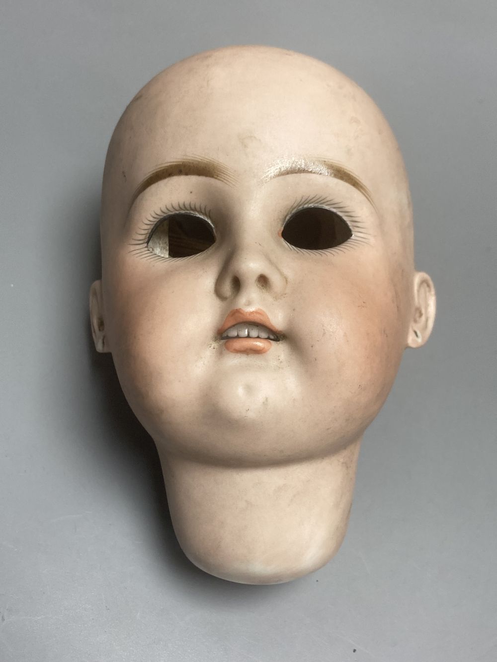 A Kammer & Reinhardt / Simon & Halbig bisque doll head, 10cm, three other German bisque doll heads and two English bisque doll heads,